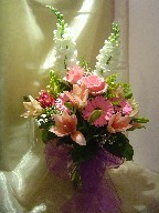 Snapdragon, roses, gerbera, lilies, alstroemeria, solidago, and waxflowers