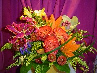 Roses, lillies, statice, solidago, orchids, fresia, pompoms, and monkey grass