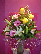 Roses, gerbera, casablanca, monte casino white, bouvardia, tulips, and waxflowers