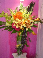 Mango calla lillies, shocking lillies, cymbidium orchids, roses, snapdragon, gerera, alstroemeria, coffee beans, ruscus Italian, sago palm, and monstera