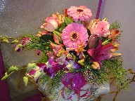 Gerbera, roses, dendrobium orchids, lillies, alstroemeria, and pine