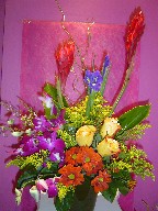 Ginger, iris, solidago, roses, orchids, daisies, and curly willow