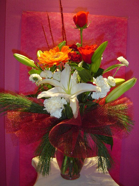 Lilies, carnations, roses, gerbera, aster, pine, and Christmas branch