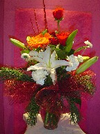 Lilies, carnations, roses, gerbera, aster, pine, and Christmas branch