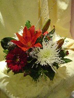 Spider mum, gerbera, lillies, hypericum, and branch