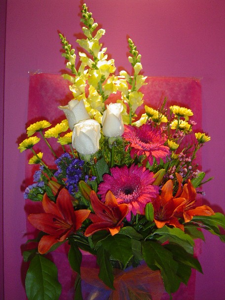 Roses, snapdragon, gerbera, lilies, daisies, and monte casino blue