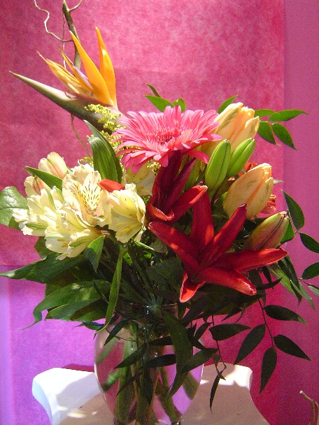 Bird of paradise, alstroemeria, tulips, solidago, lilies, gerbera, curly willow, and ruscus