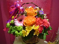 Roses, gerbera, carnations, monte casino blue, waxflowers, pompoms, alstroemeria, and lillies