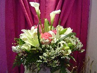 Calla lillies, lillies, roses, alstroemeria, thryptomene, Queen Anne's lace, and monkey grass