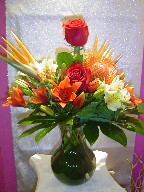 Roses, alstroemeria, bird of paradise, protea, lillies, and coffee beans
