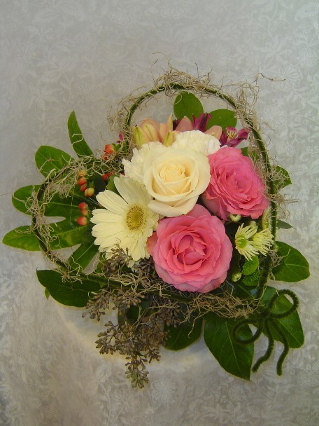 Roses, gerbera, hypericum, alstroemeria, daisies, eucalyptus, and fatsia japonica