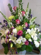 Roses, snapdragon, asiatic lillies, spider mums, flat mums, statice, and myrtle