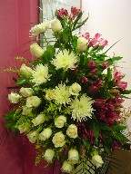 Alstroemeria, spider mum, roses, lillies, and solidago