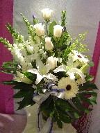 Snapdragon, roses, iris, lillies, solidago, ruscus, gerbera, alstroemeria, and monstera