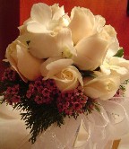 White orchids (dendrobium), vendela roses, and waxflowers