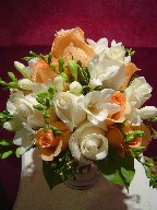 Freesia, roses, and waxflowers