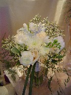 Roses, ranunculus, dusty miller, spider mum, fresia, thryptomene, peonies, variegated pitt, tiki, and monkey grass
