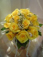 Yellow roses and waxflowers