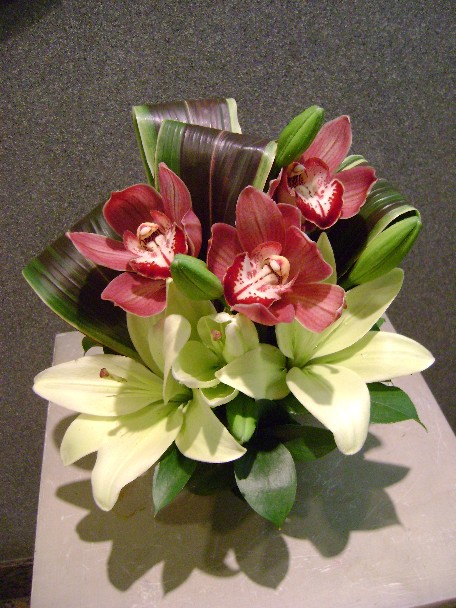 Cymbidium orchids, lilies, and cordeline