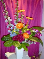 Delphinium, celosia, gerbera, dendrobium orchids, solidago, eucaplyptus, and aspodestra